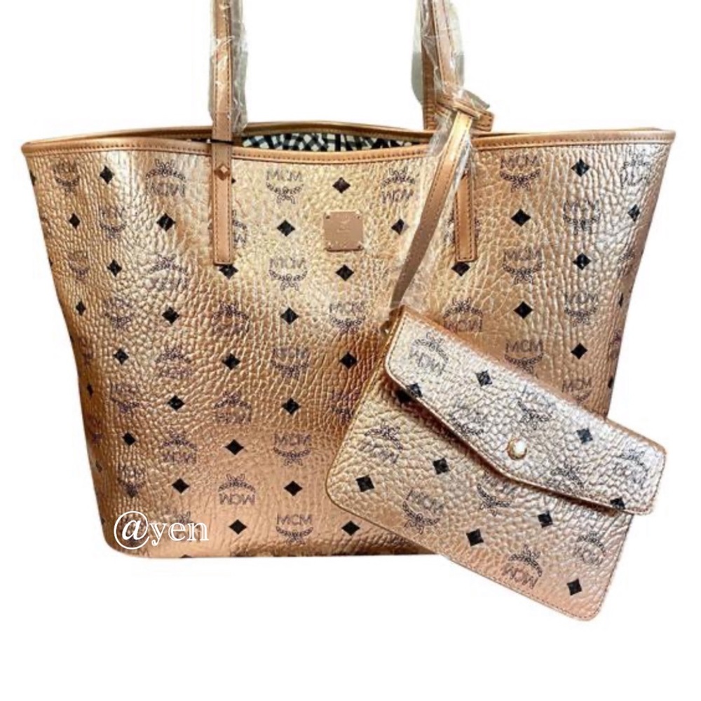 Medium logo Metalic coated canvas tote….. used carried a few times no scratches